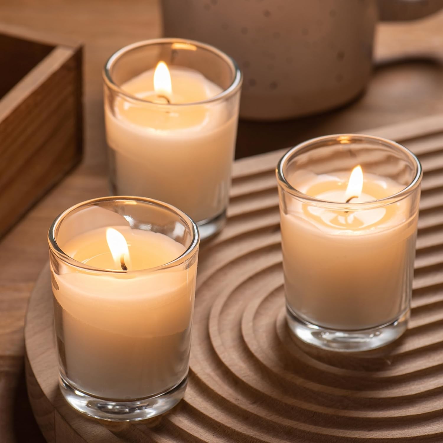 24-pack Warm White Unscented Clear Glass Cup Votive Candles.