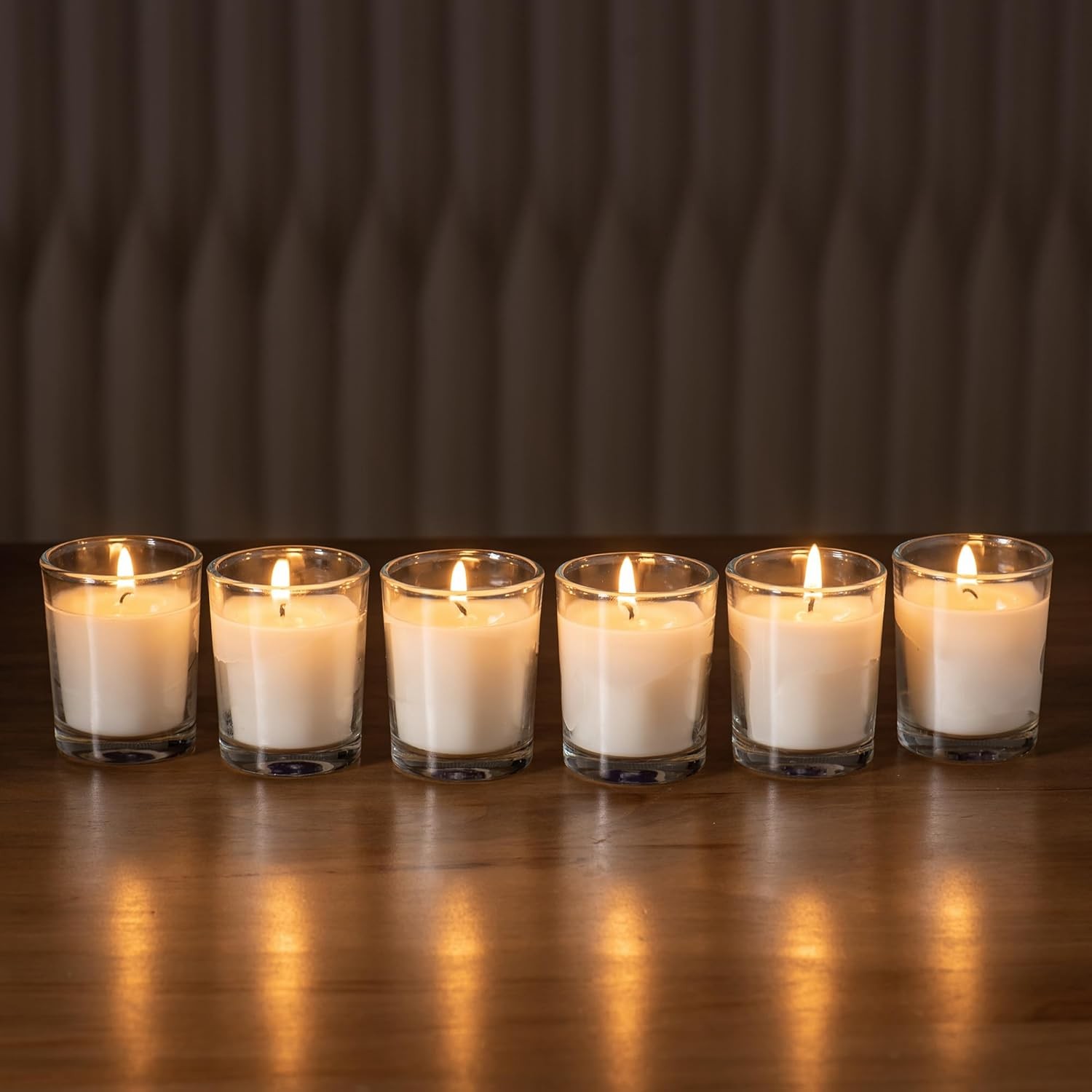 24-pack Warm White Unscented Clear Glass Cup Votive Candles.