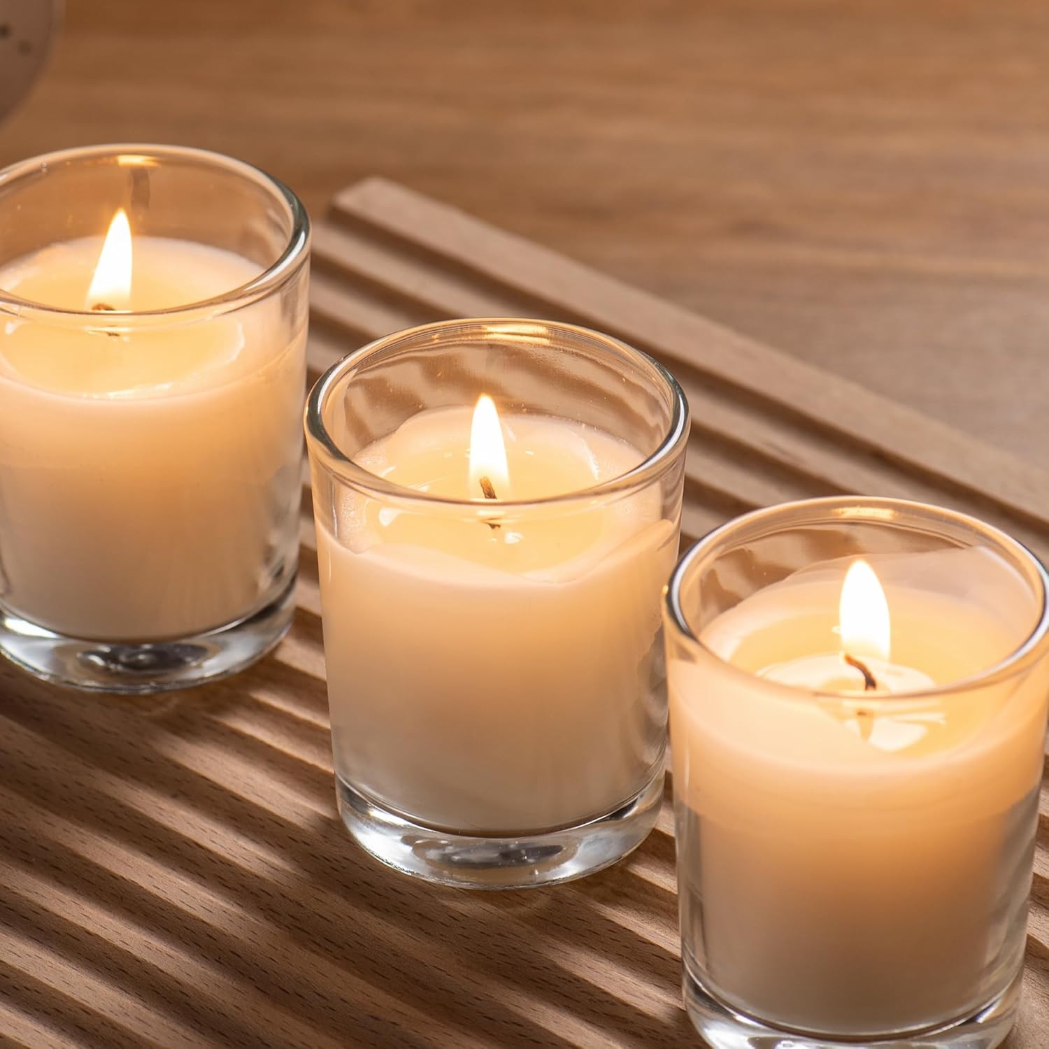 24-pack Warm White Unscented Clear Glass Cup Votive Candles.