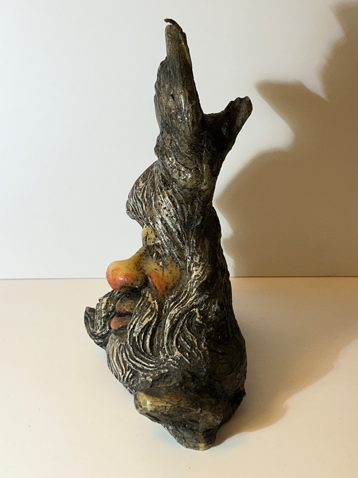 folk art candle face in a tree