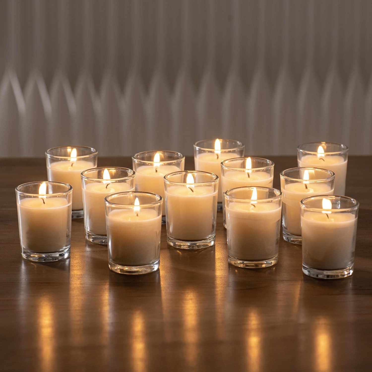 24-pack Warm White Unscented Clear Glass Cup Votive Candles.