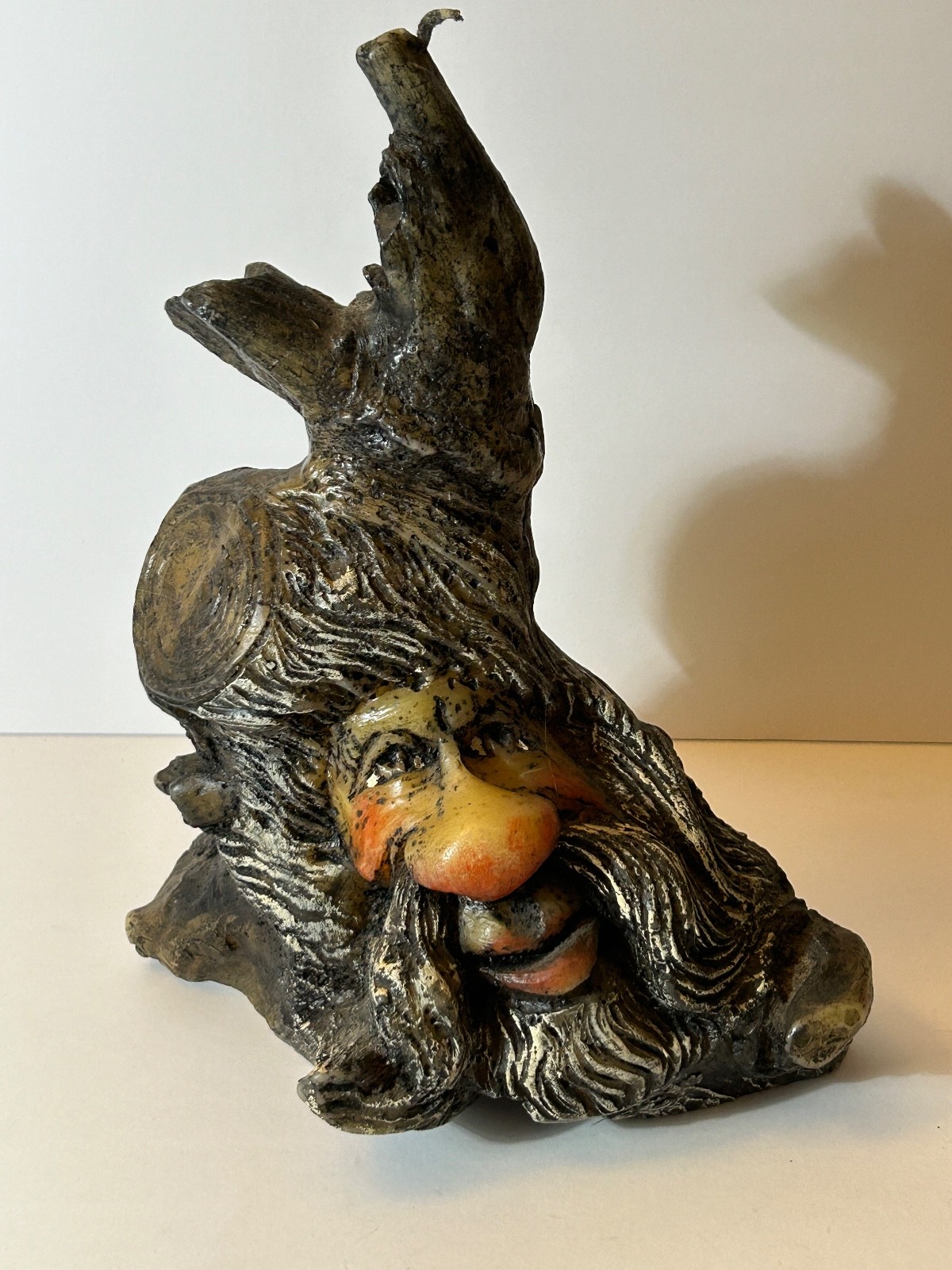 folk art candle face in a tree