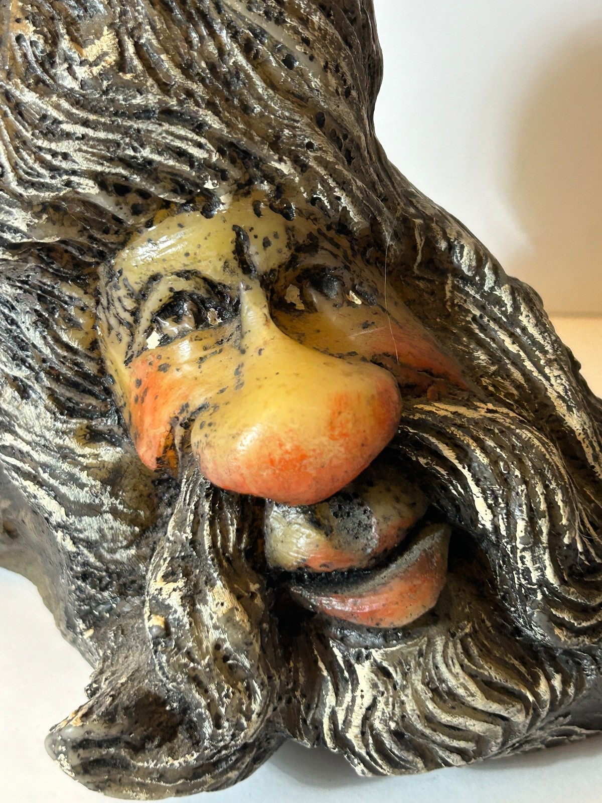 folk art candle face in a tree